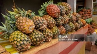 Pile of fresh pineapples on display at street market in Madagascar