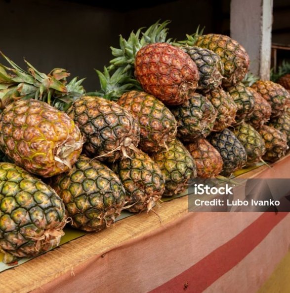 Pile of fresh pineapples on display at street market in Madagascar